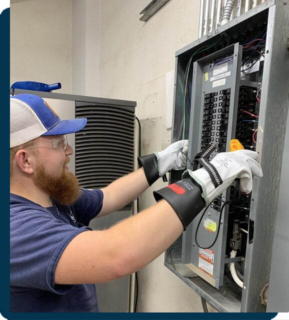 electrician working on breaker panel