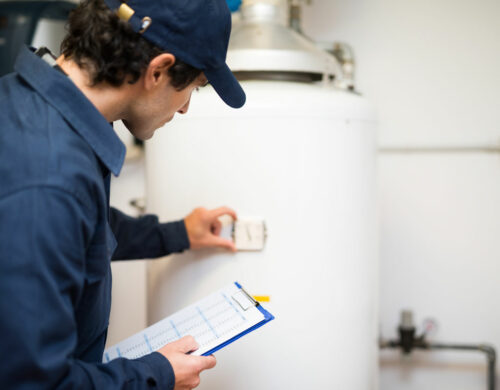 technician performing Water Heater Repair in Holly Springs, NC