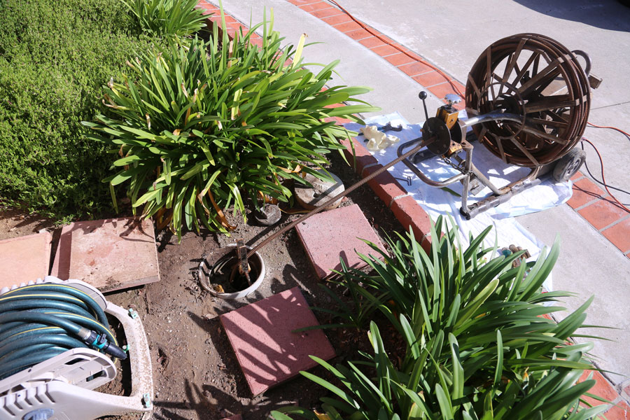 Sewer line cleaning in Apex, NC, to remove tree roots from damaged, leaking sewer line pipe